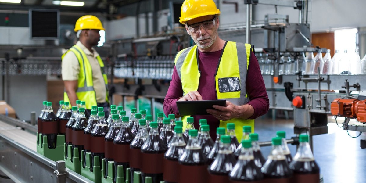 factory-worker-with-digital-tablet-monitoring-drinks-production-line-xxl